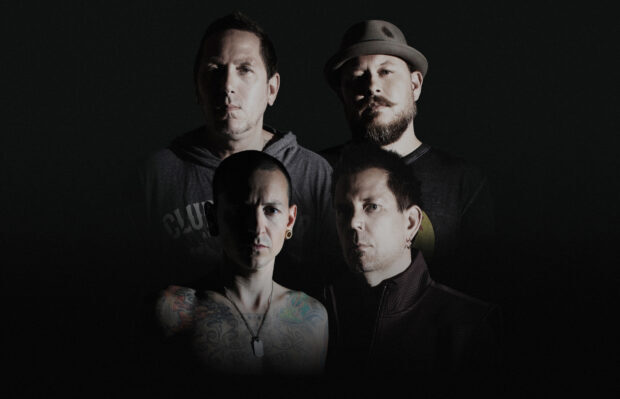 Linkin Park band members posing for a dark moody portrait with tattoos and piercings visible