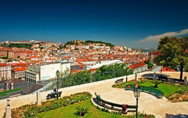 A bright day overlooking Lisbon Portugal with vibrant buildings and a clear blue sky, 2K Desktop Wallpaper