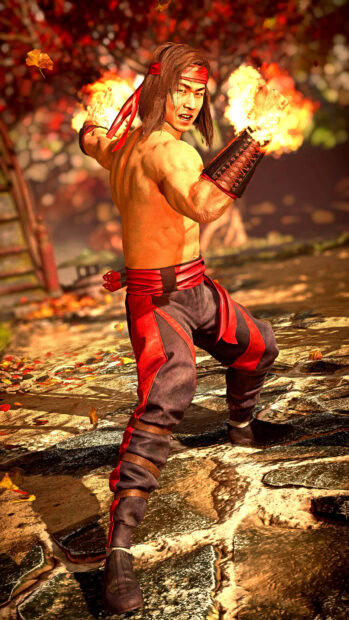 Liu Kang in fighting stance with fire powers ready in an autumn forest setting