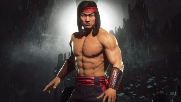 Liu Kang in a red headband showing his muscular upper body in a dark environment with mist and rocky structures
