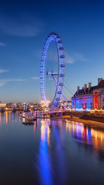 The calm river reflects the London Eye illuminated with blue lights at dusk in the cityscape, HD Phone Wallpaper