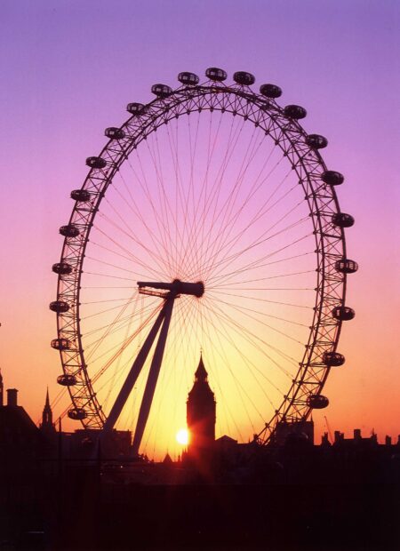 The London Eye stands tall against a purple and orange sunset sky, 2K Desktop Wallpaper