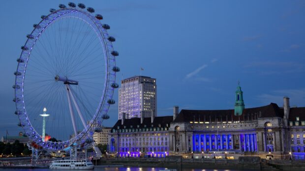 The London Eye illuminated alongside historic buildings by the river at dusk, 2K Desktop Wallpaper