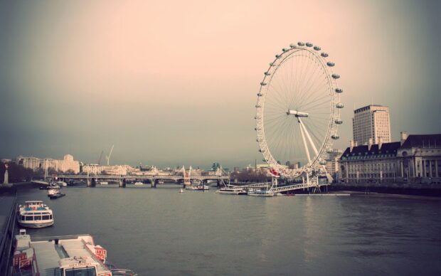 The London Eye stands tall beside the river with city buildings in the background during sunset, HD Desktop Wallpaper