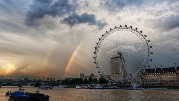 The London Eye stands tall beside the river Thames with a rainbow visible in the sky, 2K Desktop Wallpaper