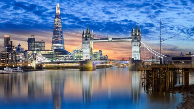 The London skyline features the Tower Bridge and the Shard illuminated at sunset, 4K Desktop Wallpaper