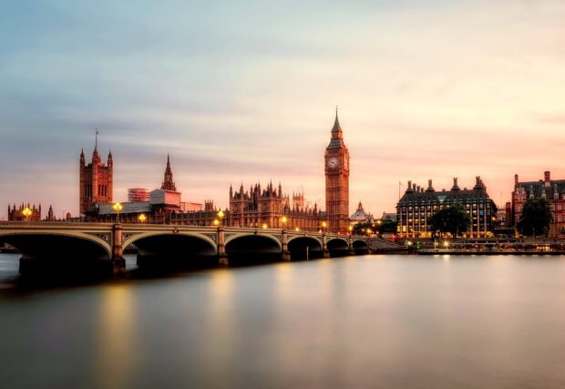 The Houses of Parliament tower over the river Thames, capturing iconic London landmarks in a peaceful evening setting., HD Desktop Wallpaper