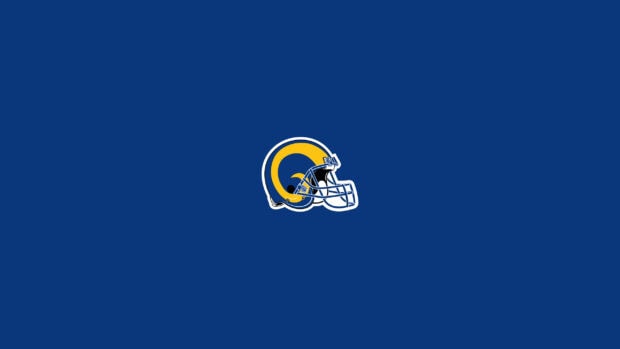 The Los Angeles Rams helmet is centered on a blue background, 2K Desktop Wallpaper