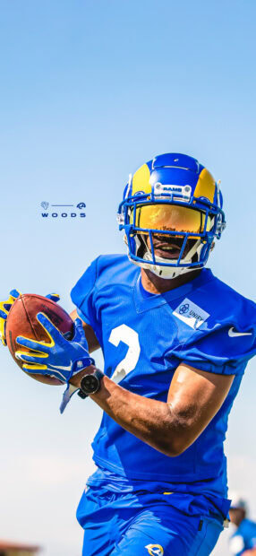 A Los Angeles Rams player catches a football during practice in a blue uniform, HD Mobile Wallpaper