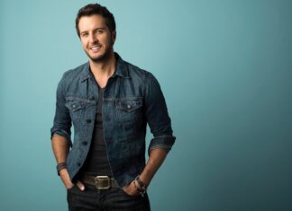 Luke Bryan smiles wearing a denim jacket against a blue background, HD Desktop Wallpaper