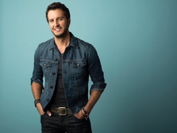 Luke Bryan smiles wearing a denim jacket against a blue background, HD Desktop Wallpaper