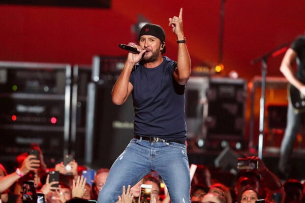 Luke Bryan is performing live on stage with an enthusiastic audience, HD Desktop Wallpaper
