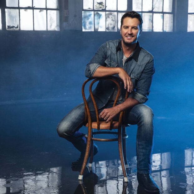 Luke Bryan sitting on a chair in a smoky room with light from the windows behind him, HD Mobile Wallpaper