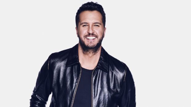 Luke Bryan smiles wearing a black leather jacket against a white background, 2K Desktop Wallpaper