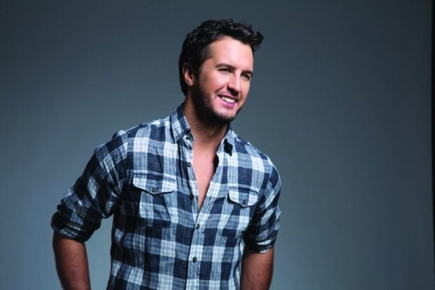 Luke Bryan smiles wearing a blue and white plaid shirt against a gray background, 2K Desktop Wallpaper
