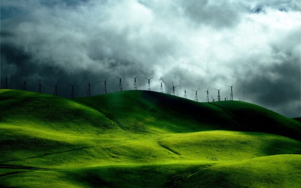 The green hills wallpapers show rolling hills with windmills under a dramatic sky, HD Desktop Wallpaper