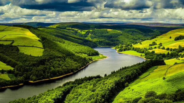 A river flows through the green hills creating a peaceful landscape with vibrant colors, 2K Desktop Wallpaper