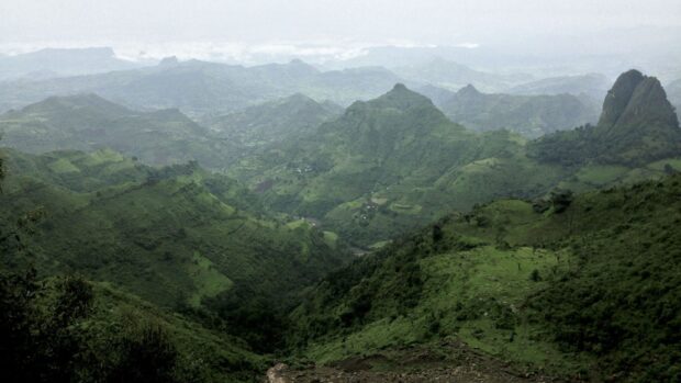 A panoramic view of lush green mountains and valleys in Ethiopia showcasing natural beauty, 2K Desktop Wallpaper