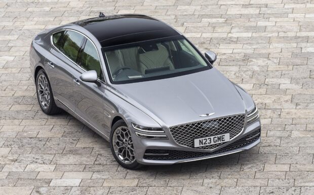 A silver Genesis car stands on a stone paved surface showcasing its design and style, HD Desktop Wallpaper