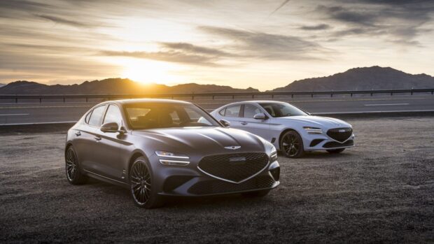 Two Genesis cars stand on an empty road at sunset in a mountainous area, HD Desktop Wallpaper
