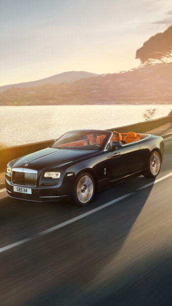 A luxury Rolls Royce Dawn drives along a lakeside road during sunset with passengers enjoying the ride, HD Mobile Wallpaper