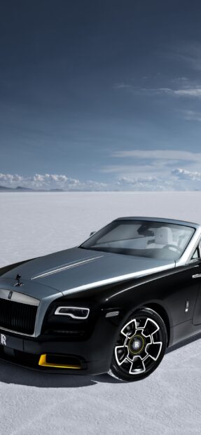 A sleek Rolls Royce Dawn shown parked on expansive white salt flats under a clear sky, 2K Mobile Wallpaper