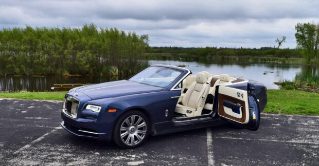 A blue Rolls Royce Dawn is parked near a lake with trees in the background, HD Desktop Wallpaper
