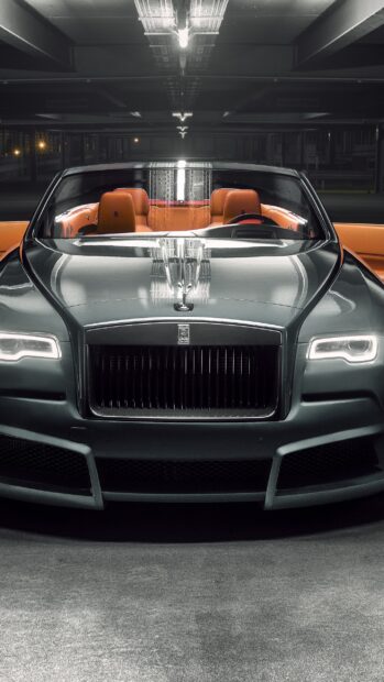 A luxury Rolls Royce Dawn with orange leather seats is parked in a garage at night, 2K Phone Wallpaper