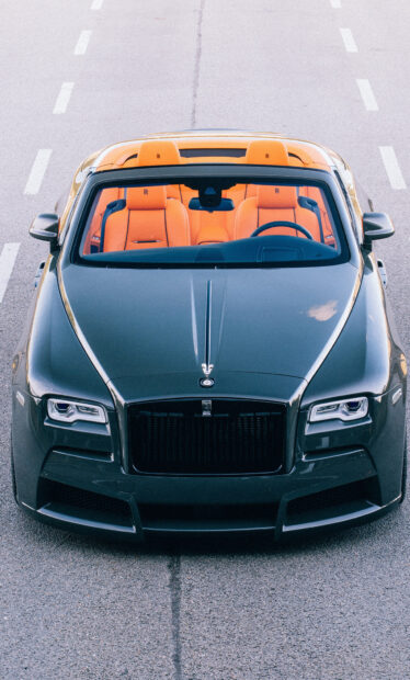 Luxury Rolls Royce Dawn with vibrant orange seats viewed from front on the road, HD Mobile Wallpaper