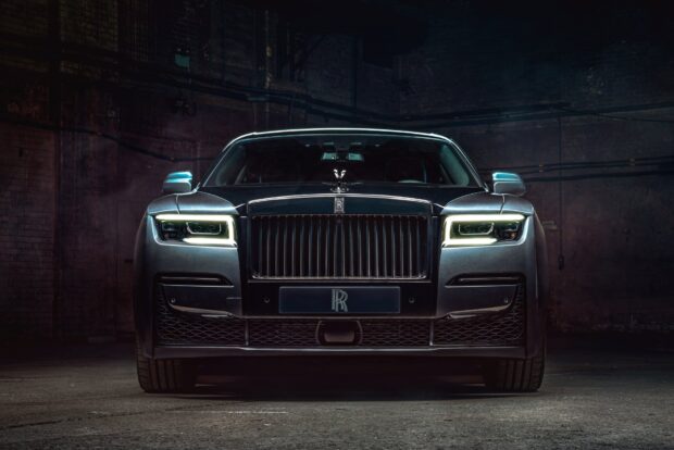 A Rolls Royce Ghost is parked in a dark industrial garage with illuminated headlights, HD Desktop Wallpaper