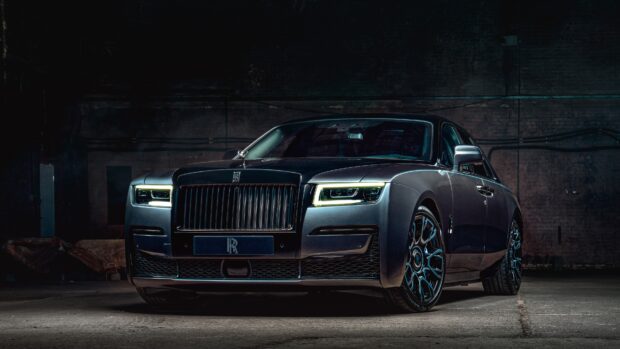 A luxury Rolls Royce Ghost is parked inside a dimly lit garage showing its front view, 4K Desktop Wallpaper