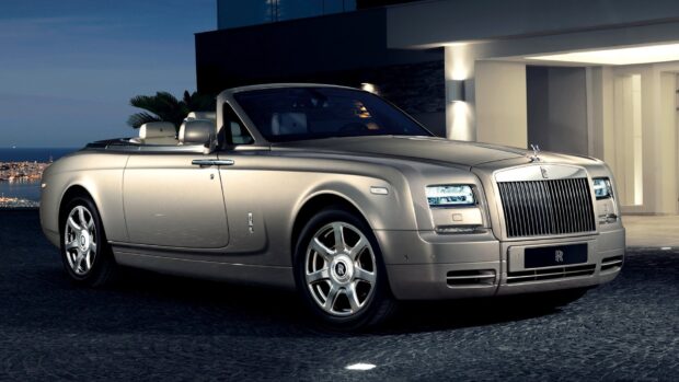 A silver Rolls Royce Phantom convertible is parked outside a modern building at dusk, HD Desktop Wallpaper