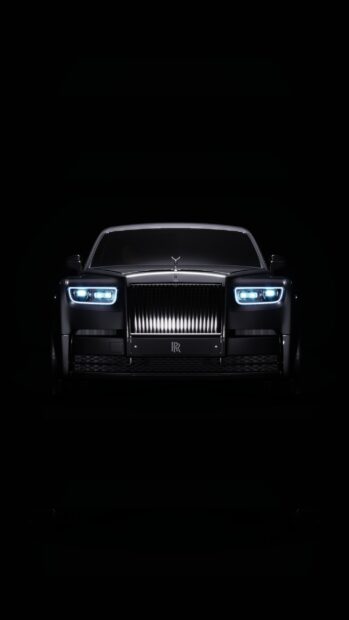 A sleek Rolls Royce Phantom is illuminated against a dark background, 2K Phone Wallpaper
