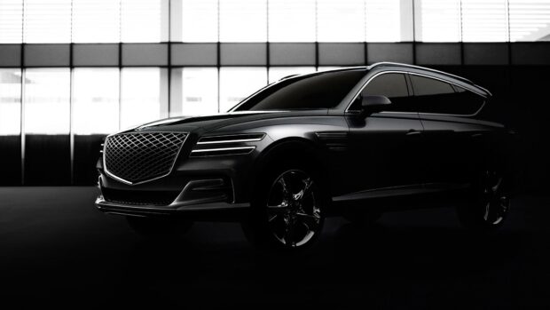 A sleek black Genesis car is parked inside a bright showroom with large windows, HD Desktop Wallpaper