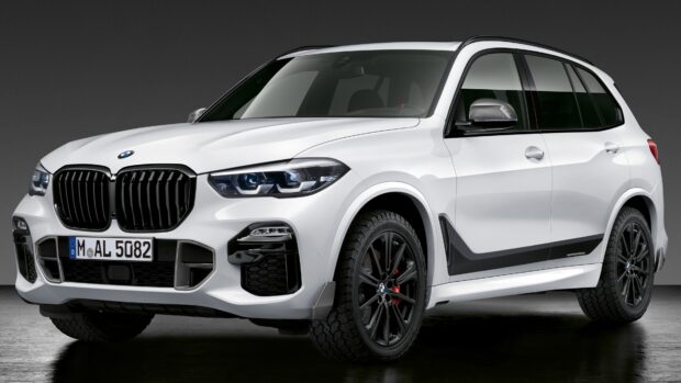 A white Bmw X5 is shown in a modern studio with detailed front design and black rims, 4K Desktop Wallpaper