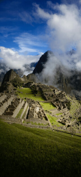 Ancient Machu Picchu ruins surrounded by mountains and clouds