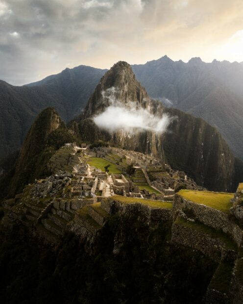 Ancient Machu Picchu landscape with mountains and clouds in the background