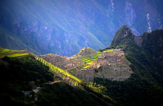 Stunning Machu Picchu ancient city ruins surrounded by lush green mountains and terraces