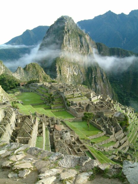 Ancient Machu Picchu ruins surrounded by mountains and mist