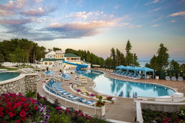 A beautiful scenic view of Mackinac Island showing a resort pool and surrounding nature, HD Desktop Wallpaper