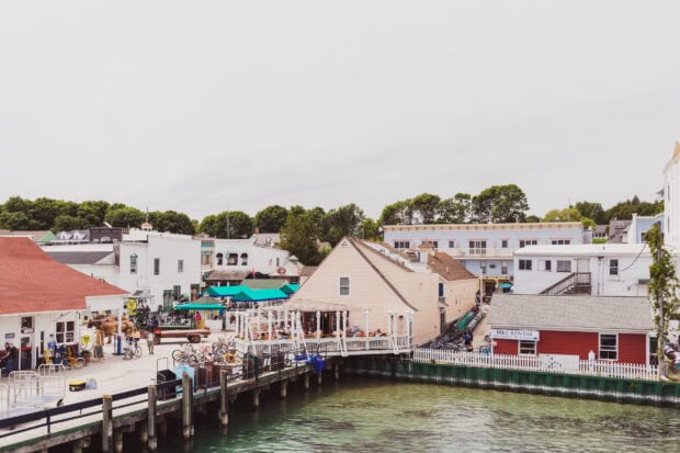 A view of Mackinac Island showing the harbor with quaint buildings and boats along the waterfront, HD Desktop Wallpaper