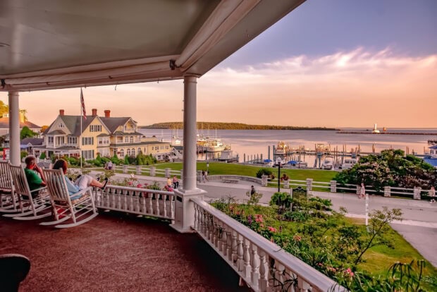 A peaceful view of Mackinac Island with people enjoying the sunset near the harbor, HD Desktop Wallpaper
