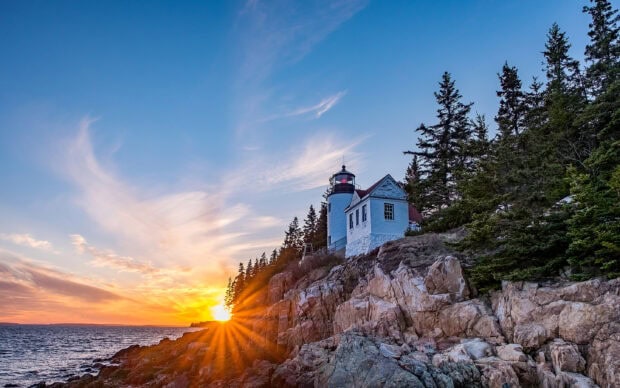 The Maine lighthouse stands tall as the sun sets over the rocky coast, Maine Wallpapers, 2K Desktop Wallpaper