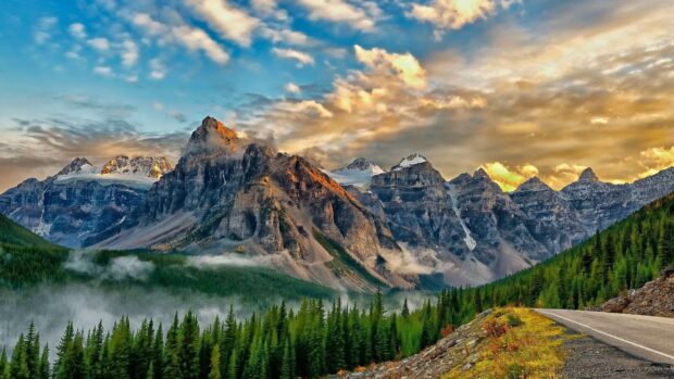 The scenery wallpapers show towering mountains with mist and glowing clouds at sunset, HD Desktop Wallpaper