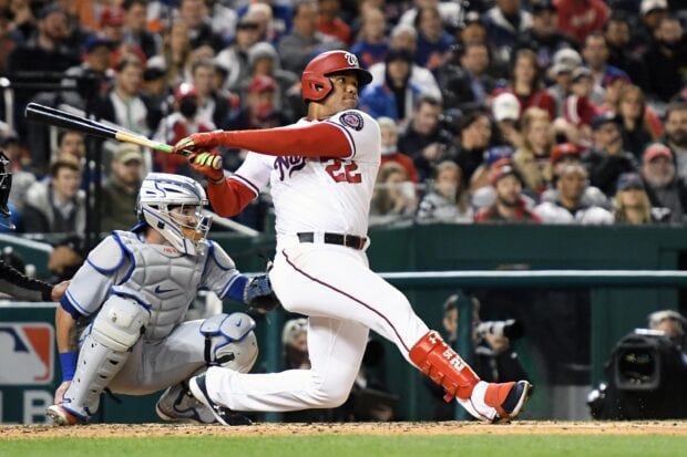 A Major League Baseball player swings the bat during a game in front of the catcher and crowd, 2K Desktop Wallpaper