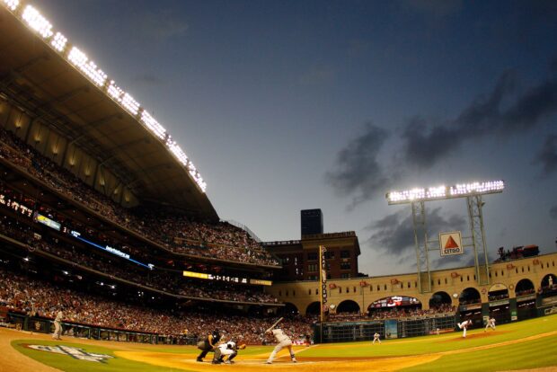 A Major League Baseball game in progress under stadium lights with players batting and fielding, 2K Desktop Wallpaper