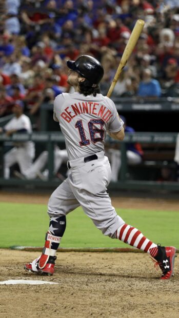 A Major League Baseball player swings a bat during a game with a blurred crowd in the background, 4K Phone Wallpaper