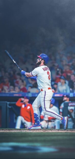 A Major League Baseball player is captured swinging the bat during a game with a focused stance, HD Phone Wallpaper