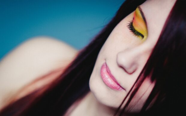 Woman with colorful eye makeup and pink lips showing natural beauty