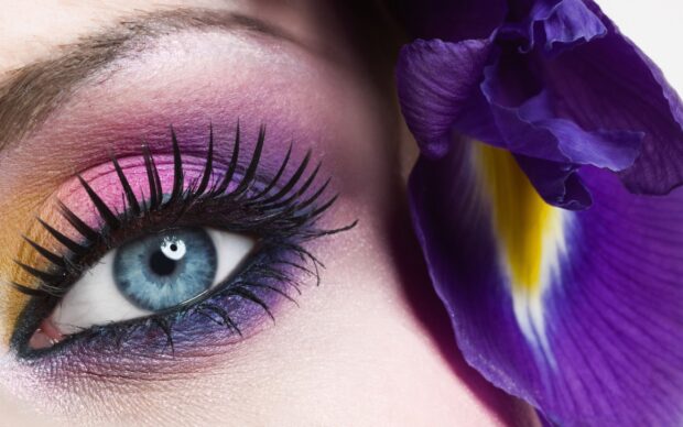 Close up of eye makeup with blue iris and colorful eyeshadow makeup